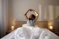 person in bed stretching